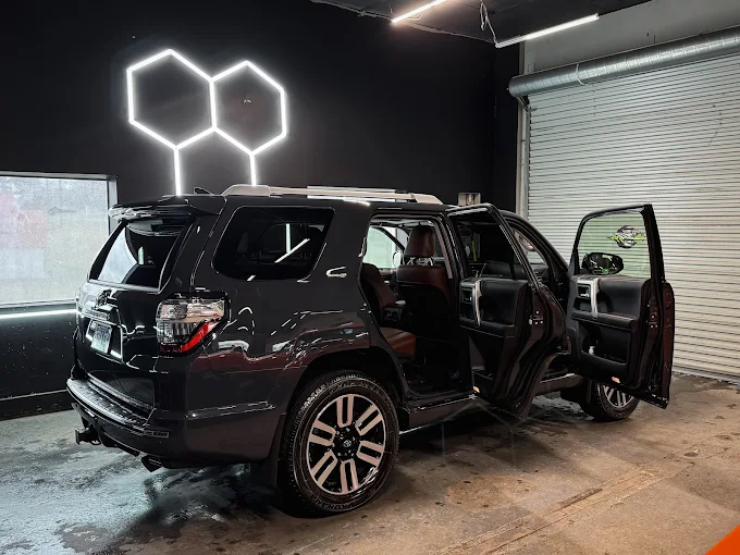 Toyota 4Runner with doors open inside the detail bay