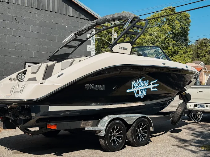 Yamaha wake boat on its trailer outside the shop