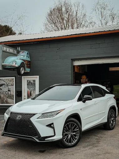 White Lexus RX in front of the shop