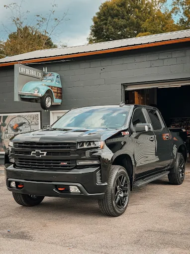 Black Chevy Silverado in front of the Lay Detail Co. sign